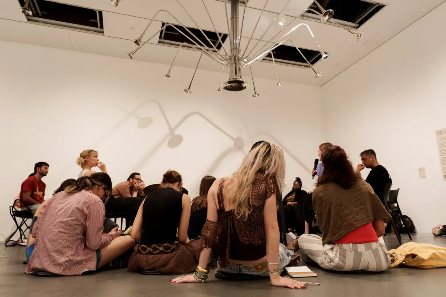 People sat in Gathering Ground exhibition at Tate Modern